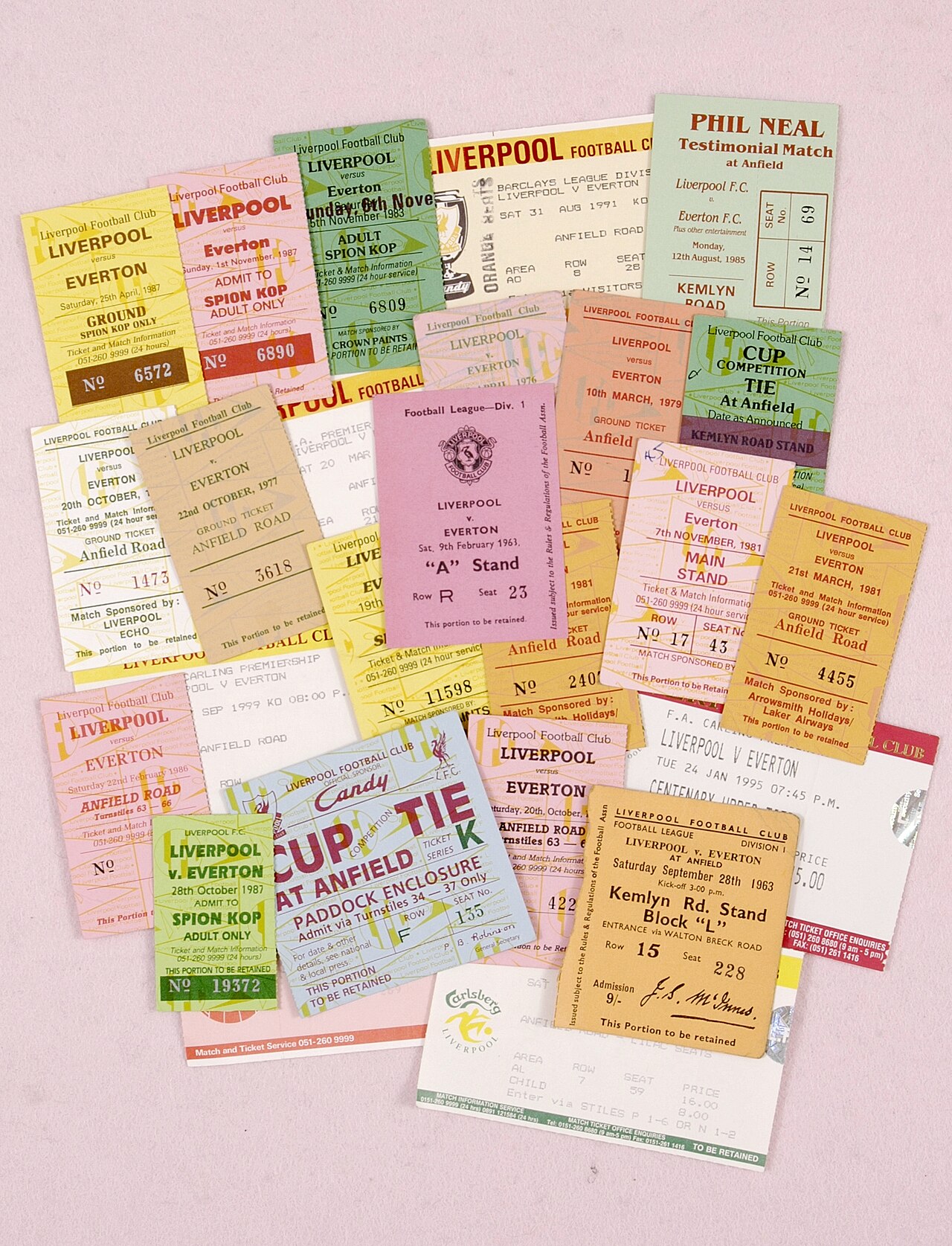 A collection of old football ticket stubs from matches between Everton and Liverpool, laid out side by side